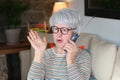 Offended senior woman on the phone