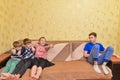 The offended teenager does not want to talk with anyone and sits separately from his brothers and sisters Royalty Free Stock Photo