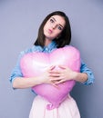 Offended young girl holding heart shaped balloon Royalty Free Stock Photo