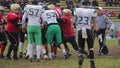 Offense team attacking defense player with ball, field official enforcing rules