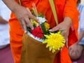 Offer sacrifice flowers to monk