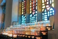 Offering candles in front of a stained glass window at Aylesford Priory Royalty Free Stock Photo