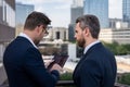 Offering deal, discussing new project. Photo of business partners talk conversation outdoor. Two handsome businessmen in Royalty Free Stock Photo