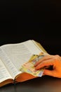 Offering romanian currency and holy bible Royalty Free Stock Photo