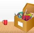 Office accessories in a cardboard box on wooden background Royalty Free Stock Photo