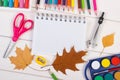 School accessories and orange leaves on white boards, back to school concept Royalty Free Stock Photo