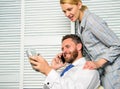 Office assistant gives massage boss help relax. Man successful businessman phone conversation while assistant do Royalty Free Stock Photo