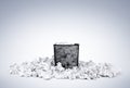 Office black waste bin full of white crumpled paper on blue background. File contains a path to isolation.