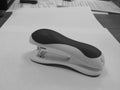 Office black and white stapler on a white paper background Royalty Free Stock Photo