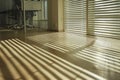 office with blinds halfopen casting striped shadows on floor