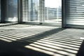 office with blinds halfopen casting striped shadows on floor