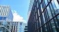 Office building, blue glass wall reflection detail. Modern office building and clear sky background. Royalty Free Stock Photo