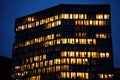 Office building exterior with glowing lights in windows at night city Royalty Free Stock Photo