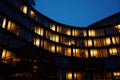 Office building exterior with glowing lights in windows at night city Royalty Free Stock Photo