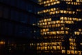 Office building exterior with glowing lights in windows at night city Royalty Free Stock Photo