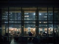 office building exterior looking through window business person meeting working late at night in meeting room