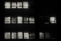 office building facade windows with venetian blinds at night