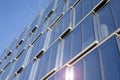 Office building glass facades on a bright sunny day with sunbeams in the blue sky. Royalty Free Stock Photo