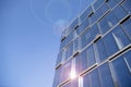 Office building glass facades on a bright sunny day with sunbeams in the blue sky. Royalty Free Stock Photo