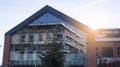 Office building glass facades on a bright sunny day with sunbeams in the blue sky. Royalty Free Stock Photo