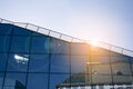 Office building glass facades on a bright sunny day with sunbeams in the blue sky. Royalty Free Stock Photo