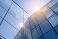 Office building glass facades on a bright sunny day with sunbeams in the blue sky. Royalty Free Stock Photo