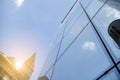 Office building glass facades on a bright sunny day with sunbeams in the blue sky. Royalty Free Stock Photo