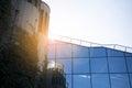 Office building glass facades on a bright sunny day with sunbeams in the blue sky. Royalty Free Stock Photo