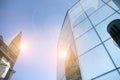 Office building glass facades on a bright sunny day with sunbeams in the blue sky. Royalty Free Stock Photo