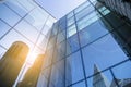 Office building glass facades on a bright sunny day with sunbeams in the blue sky. Royalty Free Stock Photo