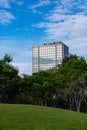 Office building and green trees under blue sky background Royalty Free Stock Photo