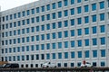 an office building with lots of windows and a large clock on the front Royalty Free Stock Photo