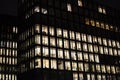 Office building with many lit windows at night in the city Royalty Free Stock Photo