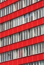 Office building with red faÃÂ§ade and tiltable windows  . Royalty Free Stock Photo