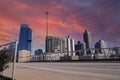 An office building under construction with workers and sliding platforms along the building surrounded by other glass skyscrapers Royalty Free Stock Photo