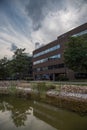 Office building under sky and reflected in water