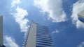 Office building under White clouds and blue sky on the warmest noon in Thailand