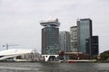 Office buildings in Amsterdam at the water IJ with ferry and tourist ship