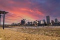 Office buildings and skyscrapers in the cityscape along Wolf Creek Harbor with bare winter trees and yellow winter grass Royalty Free Stock Photo