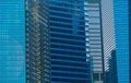 Office buildings windows. Blue glass architecture facade design with reflection of sky in urban city, Downtown Singapore City in Royalty Free Stock Photo