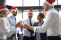 Office business coworkers celebrating winter holidays together at work and drinking champagne in office. Royalty Free Stock Photo