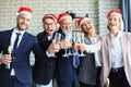 Office business coworkers celebrating winter holidays together at work and drinking champagne in office. Merry Christmas Royalty Free Stock Photo