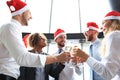 Office business coworkers celebrating winter holidays together at work and drinking champagne in office Royalty Free Stock Photo