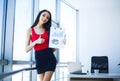 Office Business Woman Smiles and Holding Folder with Diagrams. W Royalty Free Stock Photo