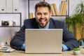 Office businessman hiding behind laptop computer making funny silly face fooling around, disrespect Royalty Free Stock Photo