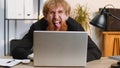 Office businessman hiding behind laptop computer making funny silly face fooling around, disrespect Royalty Free Stock Photo