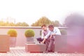 Businessmen using laptop while sitting at terrace