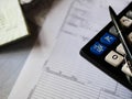 Office calculator and a pen over documents close up shot Royalty Free Stock Photo