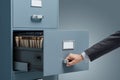 Office clerk searching files in a filing cabinet