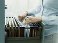 Office clerk searching files in the filing cabinet Royalty Free Stock Photo